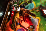 Detail of Fliper Stern Jurassic Park Home Edition Plus with dinosaur graphics and illuminated playfield.