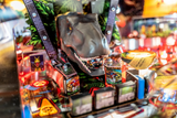 Fliper Stern Jurassic Park Home Edition Plus game featuring a detailed dinosaur model and vibrant game elements.