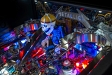 Fliper Metallica Remastered premium pinball machine features a vibrant, illuminated skeleton figure with colorful lights.