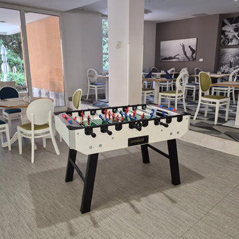 A cozy lounge area featuring a foosball table, ideal for enjoying Namizni Nogomet with friends or family.