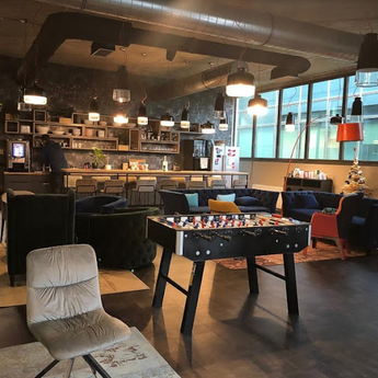 A cozy lounge area featuring a foosball table, ideal for enjoying Namizni Nogomet with friends or family.