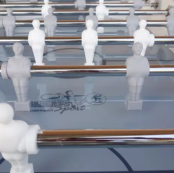 Namizni Nogomet Roberto Sport Summer Joy foosball players on a table with metallic rods, designed for outdoor use.