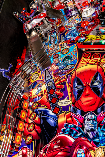 Fliper Stern Deadpool pinball machine artwork featuring vibrant colors and action-packed graphics.